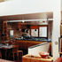 The kitchen is a step down from the dining area so the person cooking is on the same level as guests