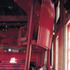 The exposed red steel contrasts with the rough existing walls