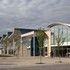 To the right is a square public entrance canopy and library, to the left is the sheltered schools
