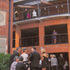Audience gathers on external terrace and balconies