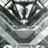 Vertical view into the apex of the reading room brings together the essential elements of the design: the ventilating fans of the roof as an environmental system, and the access galleries to the two teaching rooms that form the two arms of the plan