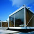 The new white coated frame helps the house float. Note the vertically pivoting ventilation louvres