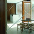 View of the living room into the reorganised kitchen - the fully glazed wall into the garden now has central doors