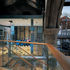 View from new steel structural platform looking east onto meeting room framed in structural glass walls and ahead the chapel