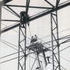Membrane being hoisted up by the main cables and guided by temporary fixings