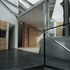 The end of the ramp down; dining room entrance between chimney stack and screen wall