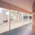 Curved cherry wood wall, colonnade and central atrium