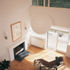 Living space with reinstated fireplace, new radiator and, at upper level, the only remaining original window framing