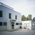 The front mixes strip windows with sash proportions. The former garage is now a gym
