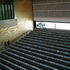 Plywood with gold embossed enlarged wood-grain pattern lines the auditorium