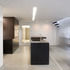 The kitchen cupboards have wenge veneer and spray-lacquered finishes, with precast-concrete panel at low level
