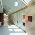 Corridor leading to classrooms, with coloured wall dividing it from the library