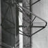 Steel column with outriggers to steady and tension rods to support the glazing