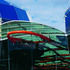 The glazed roof and floating red steel cross cover circulation space and extend in to the entrance canopy
