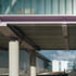 A glazed bridge links the buildings and marks the edge of the landscaped court