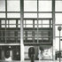Portion of internal elevation of southern arcade; on left is a pub; on right and outside the market. Above ground floor the pub is clad in reflective glass and above that is the clear glass clerestory