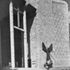 Western porch and bapistery window showing statue of St Michael in conflict with the devil
