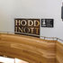 The letters of Hoddinott are evenly spaced across two lines on the audience entrance doors, with the second ‘o’ conveniently formed by central pair of door handles