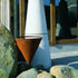 Water from the overhanging roof is collected in a Cor-ten hopper and channelled into a gravel-covered gulley