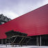 A workmanlike container once clad in corrugated sheet steel, but now reclad in black-painted steel sheeting and red GRP