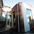 The extension is clad in distinct bronze and translucent panels