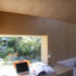 The structure integrates furniture into the construction. The window sil extends inwards to form a desk