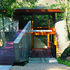 The first-floor bridge leads to the main public floor while the lower-level entrance gives access to the guest rooms and pool