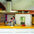 The kitchen area overlooks the dining space.  Splashes of colour are used throughout the project
