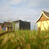 The hut stands out next to the more traditional beach huts