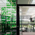 The building is a long, two-storey street which uses a lot of glass, much of it double-glazed partitions