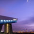 The translucent overcladding is backlit by night and reveals the structural depth of the construction