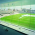 The glazed facade provides a panoramic view out onto the pitches