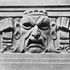 Carved mask in artificial stone