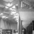 The library from the entrance end, with purpose designed bookshelves and tables and special chairs designed by Saarinen for the Embassy. The balcony for further book-stacking engages the columns of the main structure visually, but not structurally