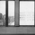 Standard window detailing in an office on an upper floor; the dark mullion between the opening lights corresponds to one of the gold-anodised mullions of the exterior views