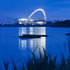The illuminated stadium reflected in the water