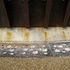Concrete upstand designed so that water runs-off leaves streaks as continuation of fins