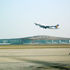 Airplane taking off above new terminal