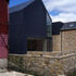 Zinc-clad, stone and timber structures together