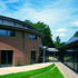 Auditorium and glass cloister with stable lock showing behind