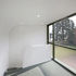 The solid balustrade in the first-floor bedroom typifies the opaque architectural idiom