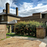 Fuchsia Cottage - external view due south east - ground floor drive + extension + fuchsia bush