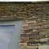 A close up of the curved masonry wall