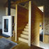 The floor of the living room is inbetween the kitchen and the upper level