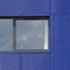 The blue mesh cladding that gives the unit a bold external presence