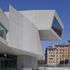 The upper gallery cantilevers over the facade