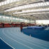 The running track sits under a giant set of louvres that shade the athletes from the sun and flood the hall with a soft and even light
