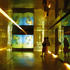 Surrounded by polished brass surfaces in the temporary exhibition space