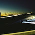 Rooflights bring in light into the building below, they are visible as the light shines back out hough them in this night view