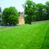 Earth mounding, with railings above south facade to right